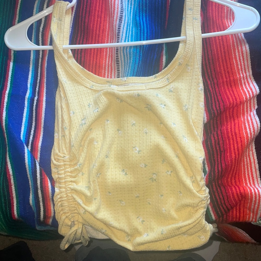 I am selling this nice floral yellow tang top perfect for the summer time